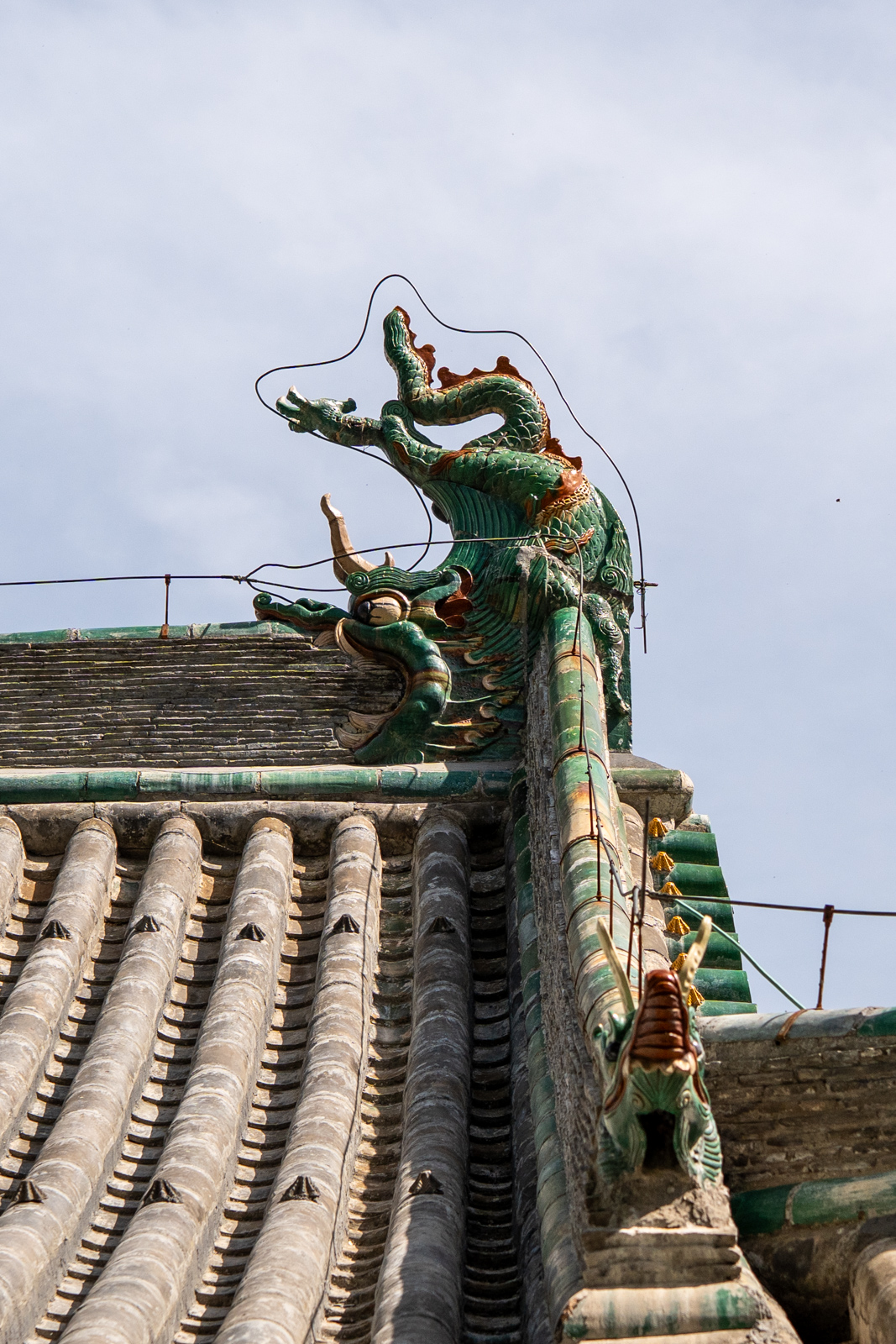 Roof detail of Chuzu Hall showing ridge and roof-end articulation.