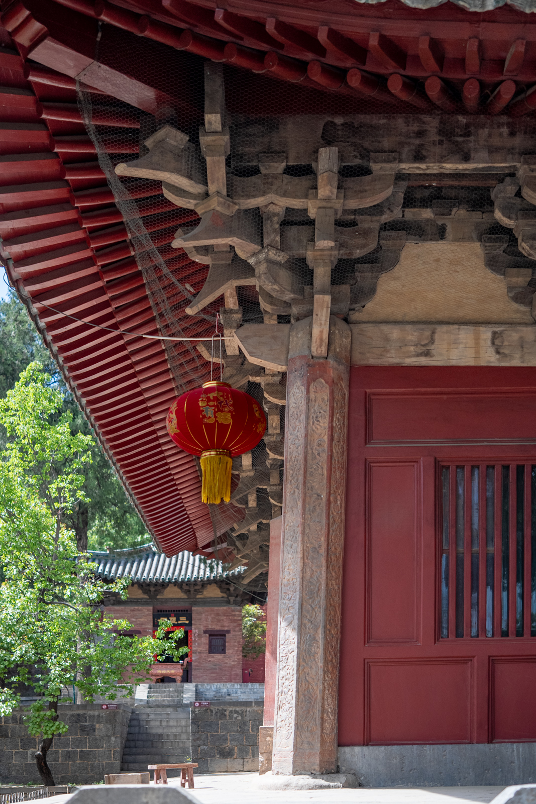 Oblique exterior view of Chuzu Hall showing the corner column inclination and deep eaves.