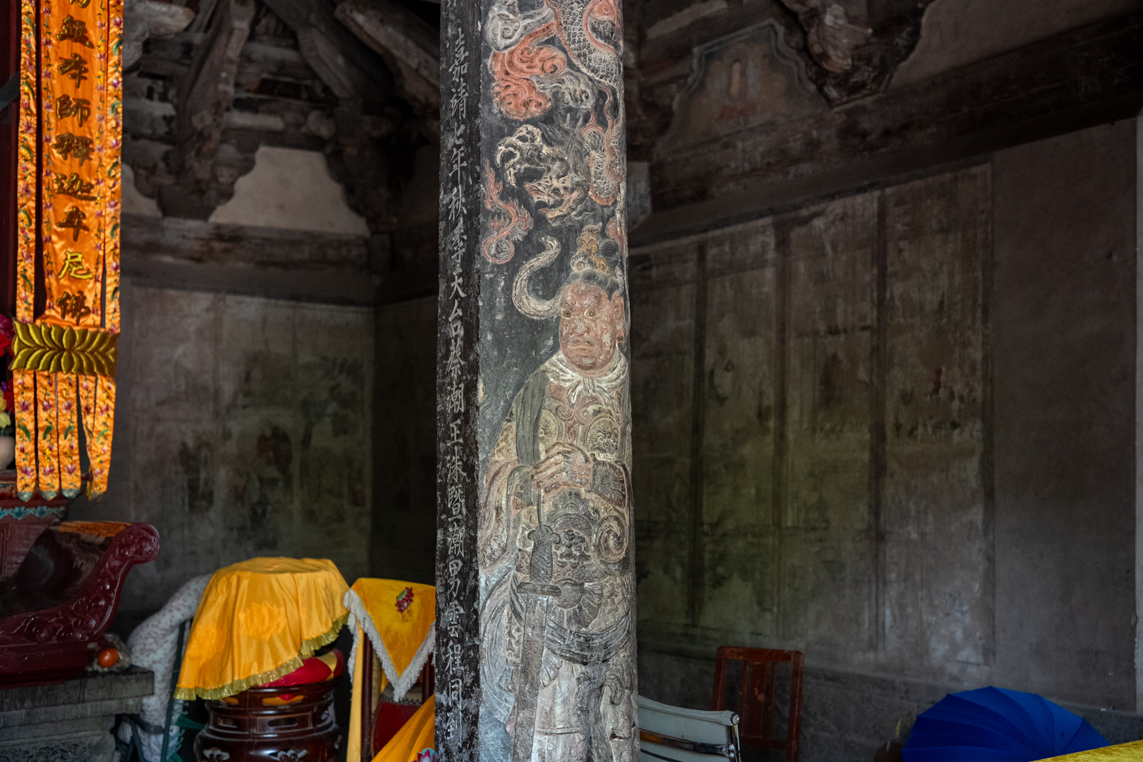 Close-up of carved detail on an interior golden column at Chuzu Hall.