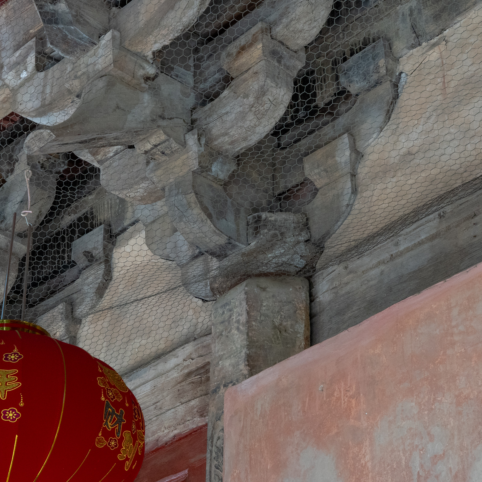 Detail of a column head and its transition into the upper timber members.